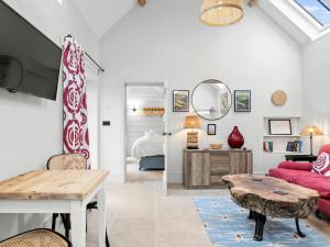 a living room with a red couch and a table at 1 Bed in Ludlow oc-92768 in Hopton Cangeford