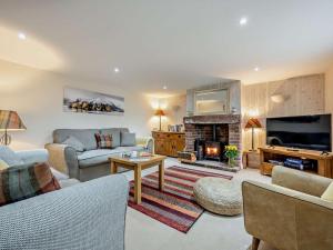 a living room with a couch and a fireplace at 3 Bed in Wigton oc-92826 in Torpenhow