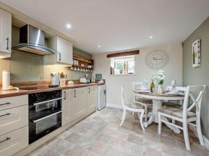 a kitchen with a table and a dining room at 3 Bed in Wigton oc-92826 in Torpenhow