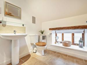 a bathroom with a sink and a toilet and a window at 3 Bed in Wigton oc-92826 in Torpenhow +18 photos