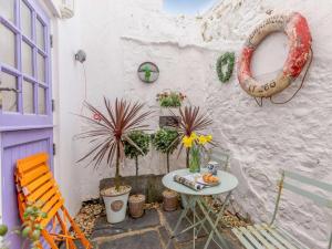 a small patio with a table and a chair at 3 Bed in Bideford oc-57804 in Appledore