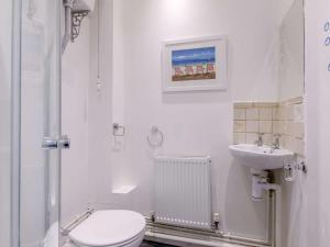a white bathroom with a toilet and a sink at 3 Bed in Bideford oc-57804 in Appledore +12 photos