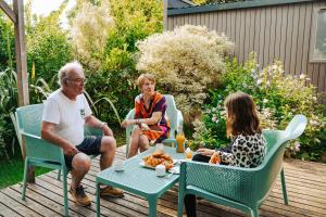 a group of people sitting around a table on a patio at Camping Erreka in Bidart