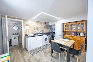 a kitchen with a table and chairs in a room at A Quintinha by YOUR KEY MADEIRA in Santa Cruz +17 photos