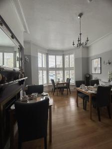 a dining room with tables and chairs and a chandelier at The Welford in Harrogate +9 photos