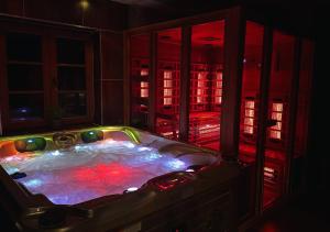 a jacuzzi tub in a room at night with lights at Rusínsky Dvor s privátnym Wellness in Malý Lipník