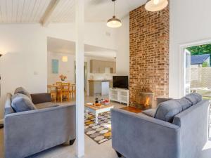 a living room with two couches and a brick wall at 2 Bed in Saltash oc-88309 in Wotter