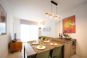a kitchen with a table with chairs and a dining room at Me amìa in Dolo +6 photos