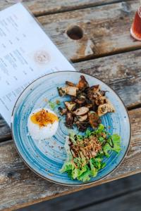 a blue plate of food on a wooden table at Camping Erreka in Bidart +21 photos