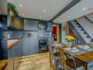 a kitchen with a table and chairs and a staircase at 2 Bed in Spalding oc-91528 in Surfleet