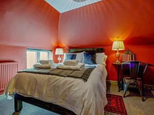 a bedroom with red walls and a large bed at 2 Bed in Spalding oc-91528 in Surfleet