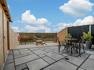a patio with a table and chairs and a bench at 2 Bed in Spalding oc-91528 in Surfleet
