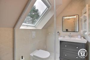 a bathroom with a sink and a window at Fontaine aman in La Roche-Jaudy +41 photos