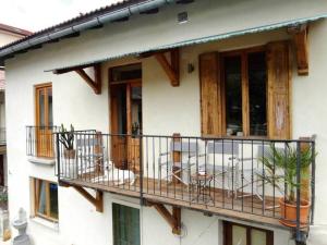 a balcony of a house with a table and chairs at Tolmin center apartments Townhouse & Loft in Tolmin