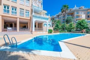 a swimming pool in front of a building at Atlantico Atico PLUS by Ĥ - Playa Punta del Moral PAHT76P102 in Isla del Moral