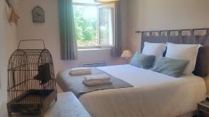 a bedroom with a bed with towels on it at Gites Domaine de Ceyrac in Conqueyrac