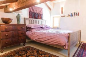 a bedroom with a bed with a dresser and a window at Tolmin center apartments Townhouse & Loft in Tolmin