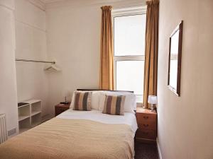 a bedroom with a bed and a large window at Beverley Dean in Blackpool +41 photos