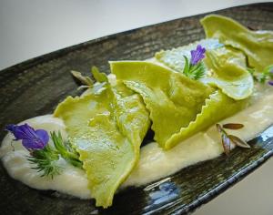 a plate with a piece of food with flowers on it at Da Arturo e Maruca in Vellano
