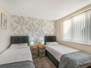 two twin beds in a room with a window at 2 Bed in Brough oc-86817 in Scalby