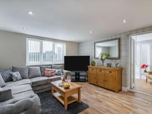 a living room with a couch and a tv at 2 Bed in Brough oc-86817 in Scalby