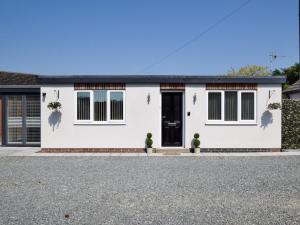 a white house with a black door on a street at 2 Bed in Brough oc-86817 in Scalby