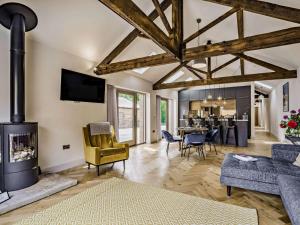 a living room with a fireplace and a dining room at 2 Bed in Driffield oc-88238 in Lund