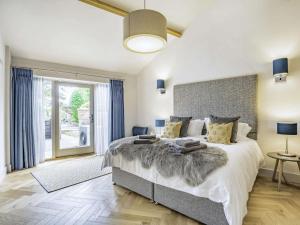 a bedroom with a large bed and a large window at 2 Bed in Driffield oc-88238 in Lund