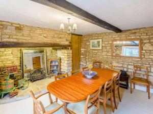 a dining room with a wooden table and chairs at 4 Bed in Oakham oc-86556 in Empingham