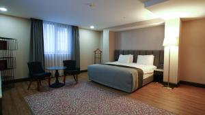 a hotel room with a bed and a table and chairs at Dosso Dossi Hotels Old City in Istanbul +146 photos
