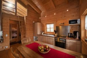 a kitchen with a bowl of fruit on a table at Pfenniggeiger-Hütte in Philippsreut