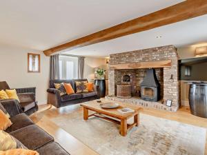 a living room with a couch and a fireplace at 3 Bed in Driffield oc-92697 in Lund