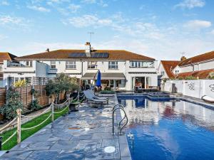 a house with a swimming pool in front of a house at 4 Bed in Bognor Regis oc-81446 in Bognor Regis