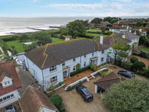 an aerial view of a large white house and the ocean at 4 Bed in Bognor Regis oc-81446 in Bognor Regis