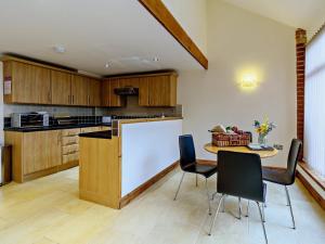 a kitchen with a table and chairs and a counter at 1 Bed in Doncaster oc-93769 in Mattersey +13 photos
