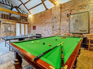 a pool table in a room with two tables at 2 Bed in Doncaster oc-93770 in Mattersey