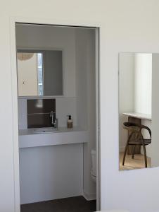 a white bathroom with a sink and a mirror at Chambres au vert - Proche aéroport et Nantes in Saint-Aignan-Grand-Lieu +31 photos