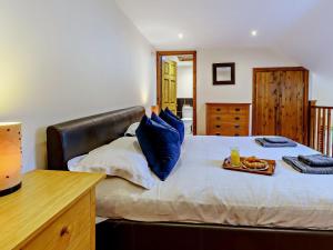 a bedroom with a bed with a tray of food on it at 1 Bed in Doncaster oc-93769 in Mattersey