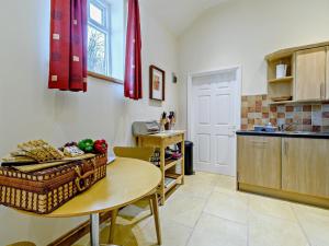 a kitchen with a table with a basket of fruit on it at 1 Bed in Doncaster oc-93768 in Mattersey