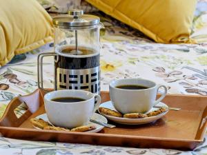 two cups of coffee and cookies on a tray at 1 Bed in Doncaster oc-93768 in Mattersey +10 photos