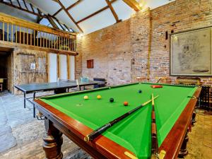a pool table in a room with two tables at 1 Bed in Doncaster oc-93768 in Mattersey