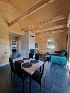 a living room with a table and a couch at Azyl na Polesiu domki przy Poleskim Parku Narodowym in Załucze Nowe +27 photos