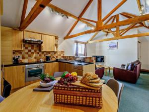 a kitchen with a table with a basket of bread at 2 Bed in Doncaster oc-93771 in Mattersey