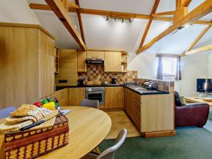 a kitchen with a wooden table in a room at 2 Bed in Doncaster oc-93771 in Mattersey +12 photos