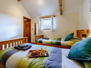 a bedroom with two beds with a tray of food on it at 2 Bed in Doncaster oc-93771 in Mattersey