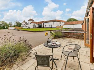 a patio with a table and chairs and a house at 3 Bed in Doncaster oc-93570 in Mattersey