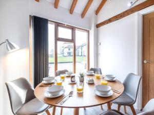 a dining room with a wooden table and chairs at 3 Bed in Doncaster oc-93570 in Mattersey