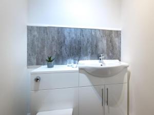 a white bathroom with a sink and a toilet at 3 Bed in Doncaster oc-93570 in Mattersey +18 photos