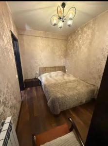 a bedroom with a bed and a ceiling fan at Cozy Corner in Tbilisi City
