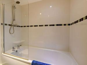 a bathroom with a tub and a glass shower at 1 Bed in Doncaster oc-93572 in Mattersey +12 photos